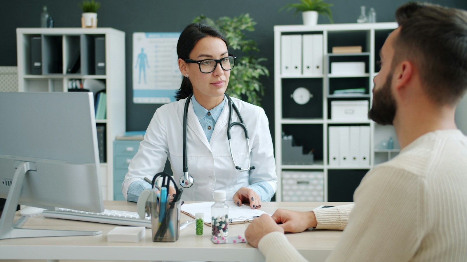 An oncologist talking with a patient across a desk